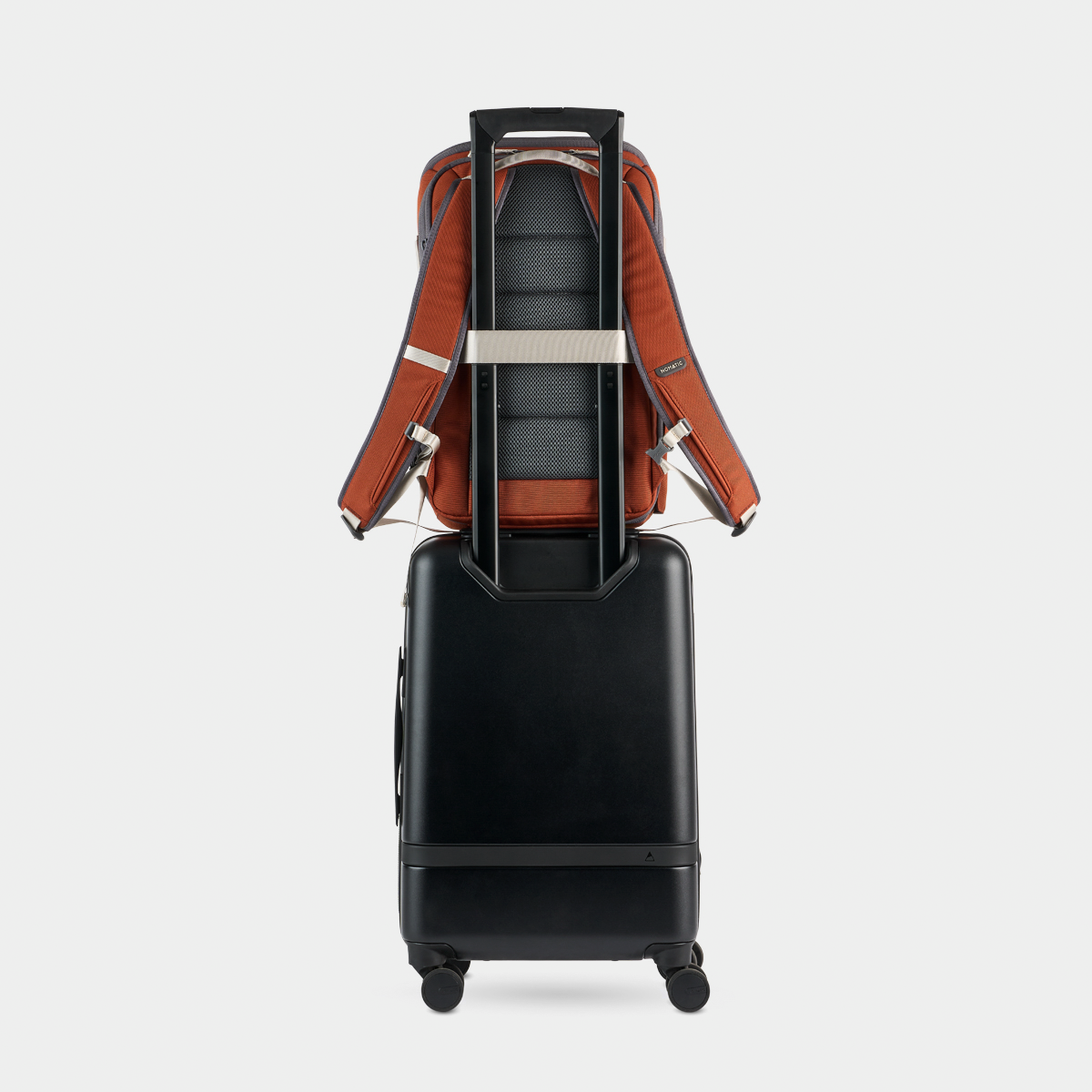 Rust Luma Camera Pack 18L On a Carry-On Back View #color_rust
